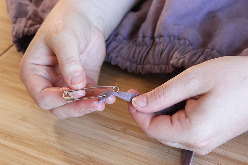 46. Tie the drawstring through the grommets 